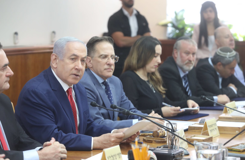 Prime Minister Benjamin Netanyahu addresses the cabinet over a bill regarding the placing of cameras in polling stations, while Attorney General Avichai Mandelblit sits in the background, September 8 2019 (photo credit: MARC ISRAEL SELLEM)