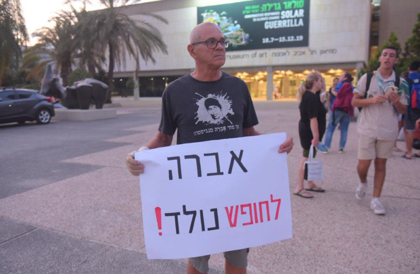 Protest outside the Tel Aviv Museum of Art calling for the release of Avera Mengistu, held in Gaza by Hamas for five years. The protster is holding a sign calling for the release of Mengistu and wearing a shirt in his support.   (photo credit: AVRAHAM SASSONI)