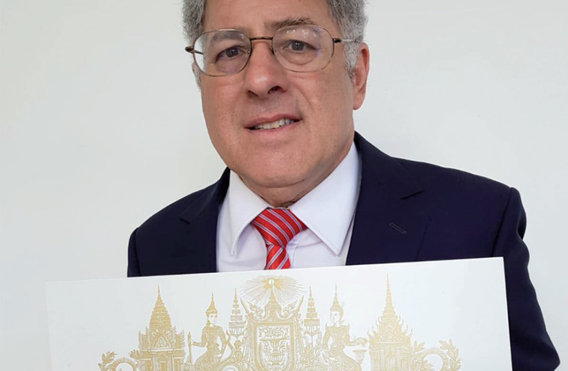 Phil Weiner holds the certificate in August certifying that he was admitted into the Royal Order of Cambodia (photo credit: COURTESY OF PHIL WEINER)