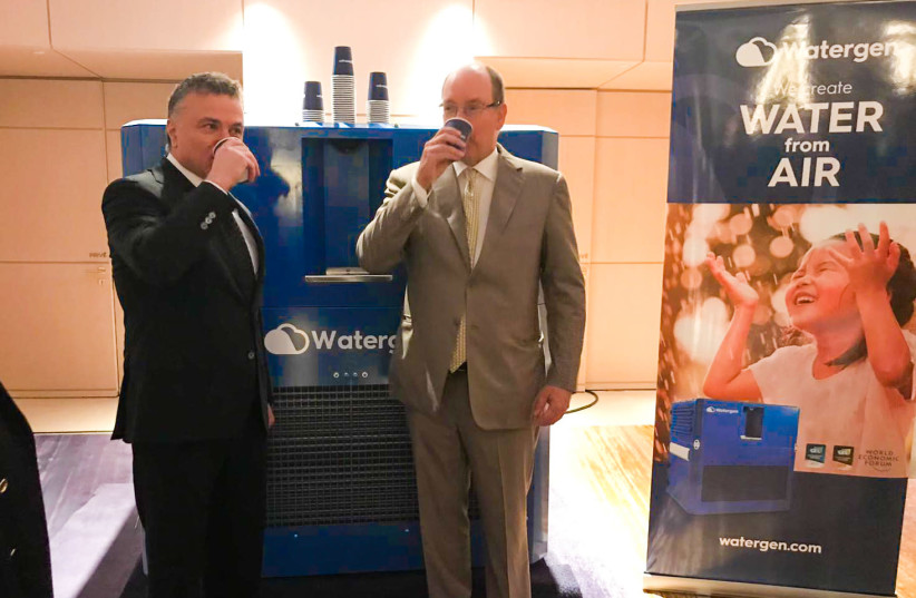 Monaco's Prince Albert II and Dr. Michael Mirilashvili drinking water-from-air last Monday. (photo credit: WATERGEN)