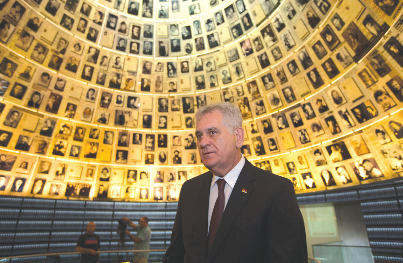 SERBIA’S PRESIDENT Tomislav Nikolic looks at pictures of Jews killed in the Holocaust during a visit to Yad Vashem in Jerusalem (photo credit: REUTERS)