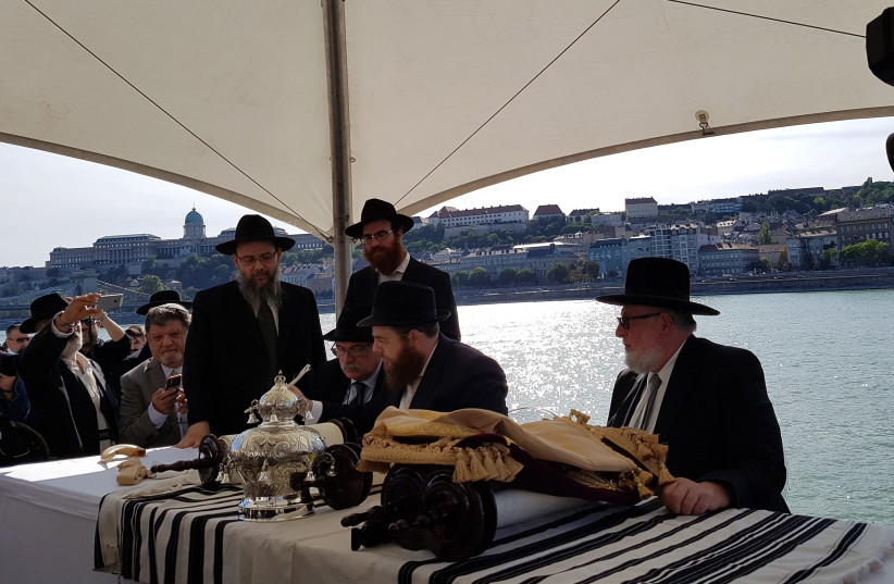  Religious leaders fill in the final letters of each newly dedicated Torah. (photo credit: ILANIT CHERNICK)