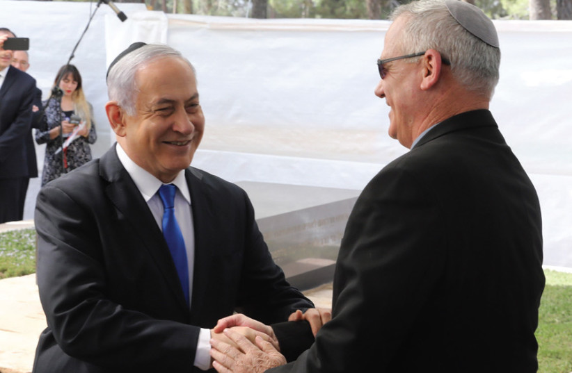 Blue and White leader Benny Gantz greets Likud leader Prime Minister Benjamin Netanyahu two days after Israel’s Election Day (photo credit: MARC ISRAEL SELLEM)