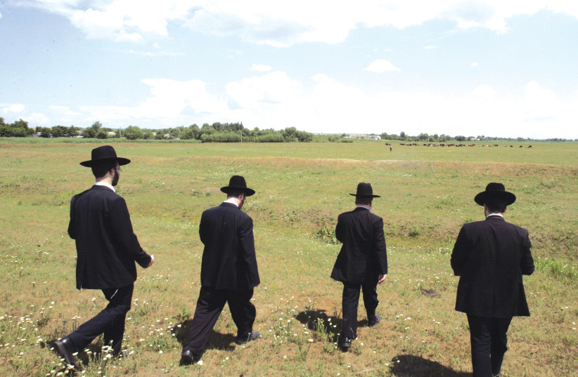 Jewish Hassidic men walking in Eastern Europe   (photo credit: REUTERS)