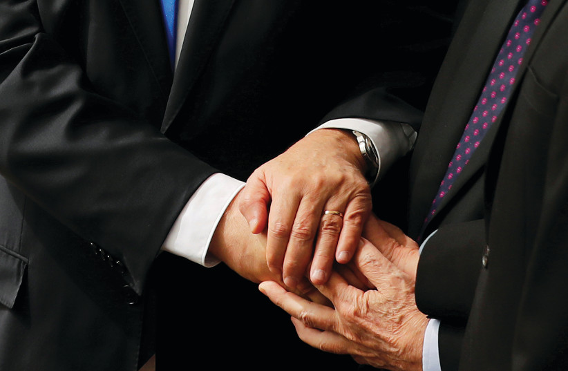 Netanyahu, Rivlin and Gantz holding hands  (photo credit: RONEN ZVULUN / REUTERS)