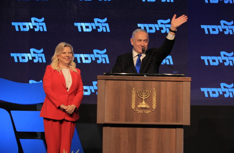 Prime Minister Benjamin Netanyahu stands on stage with wife Sara at Likud's New Years Toast, September 26 2019 (photo credit: SHARON REVIVO)