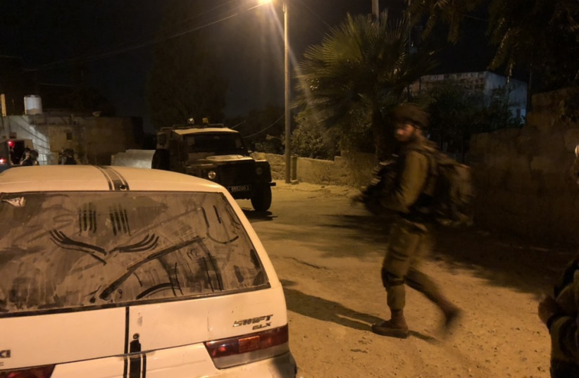 An IDF soldier in a raid in Kfar Ni'ma, near Modiin (photo credit: ANNA AHRONHEIM)