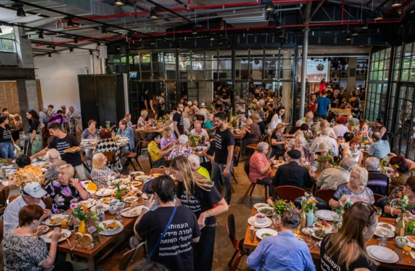 Survivors and guests eat together at the Rosh Hashanah event organized by the Association for Immediate Help for Holocaust Survivors (photo credit: GAL HAIM)