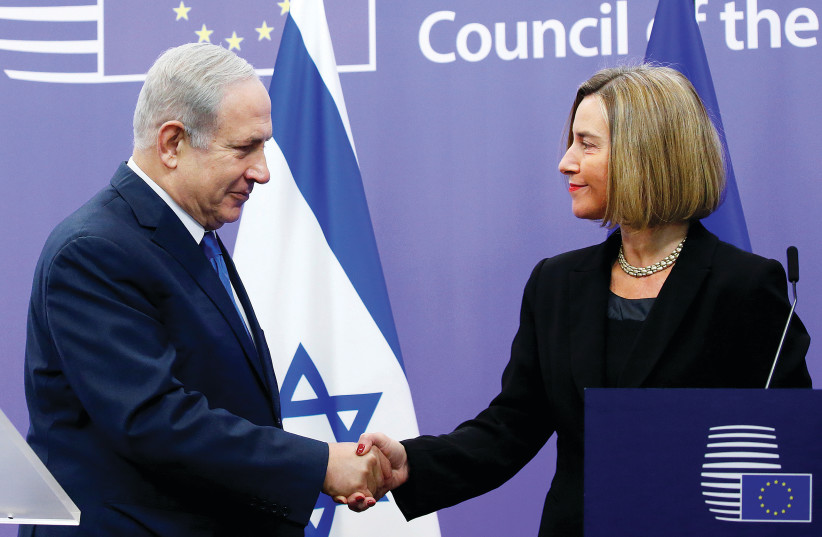 ISRAEL’S PRIME Minister Benjamin Netanyahu shakes hands with European Union foreign policy chief Federica Mogherini at the European Council in Brussels, Belgium in 2017 (photo credit: REUTERS)