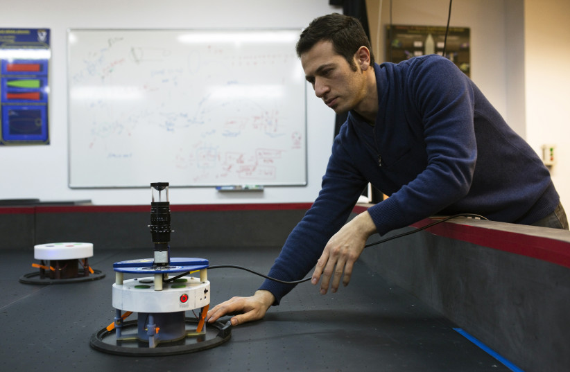 Researcher handles an autonomous robot used to test technology for the Adelis-SAMSON project, in Haifa (photo credit: REUTERS)