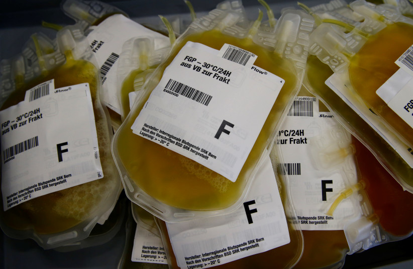 Plasma bags are pictured at the Interregional Transfusion CRS in Bern (photo credit: DENIS BALIBOUSE/REUTERS)