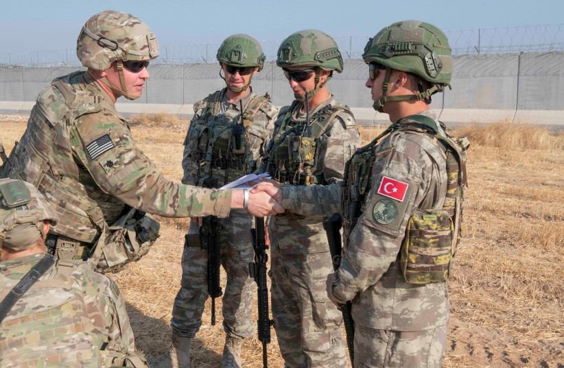 U.S. and Turkish military forces conduct a joint ground patrol inside the security mechanism area in northeast, Syria, October 4, 2019. Picture taken October 4, 2019 (photo credit: REUTERS)