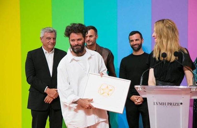 Hed Mayner accepting the Karl Lagerfeld Prize at the LVMH competition from Delphine Arnault, Director and Executive VP of Louis Vuitton. Behind them are Sidney Toledano, CEO of LVMH, Kris Van  Assche, Creative Director of Berluti, and Nicolas Ghesquière, Creative Director of the house of Louis Vuitt (photo credit: BEZALEL ACADEMY OF ARTS AND DESIGN)