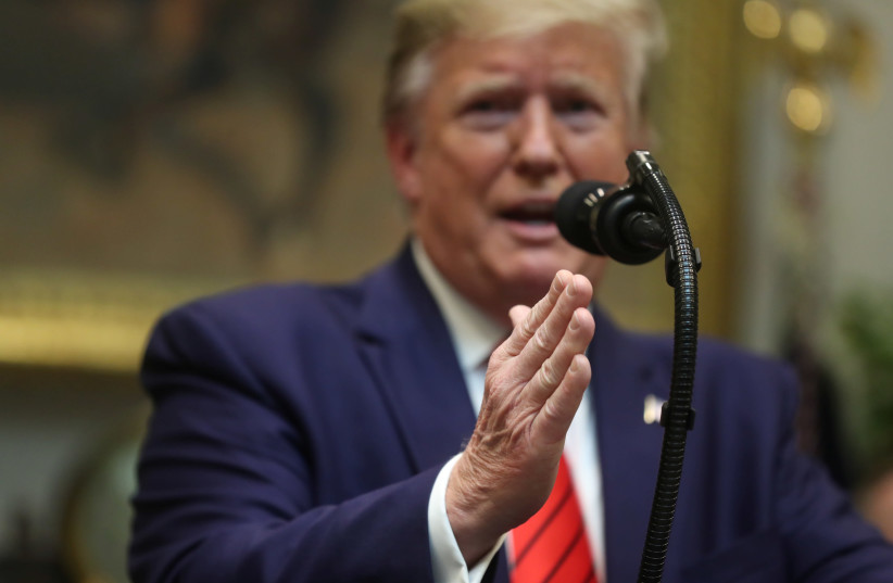 U.S. President Donald Trump answers questions from reporters during an event to sign executive orders on "transparency in federal guidance and enforcement" in the Roosevelt Room of the White House in Washington, U.S., October 9, 2019 (photo credit: REUTERS/JONATHAN ERNST)