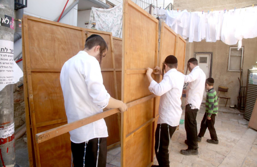 Constructng a Sukkah in Meah Shearim (photo credit: Courtesy)