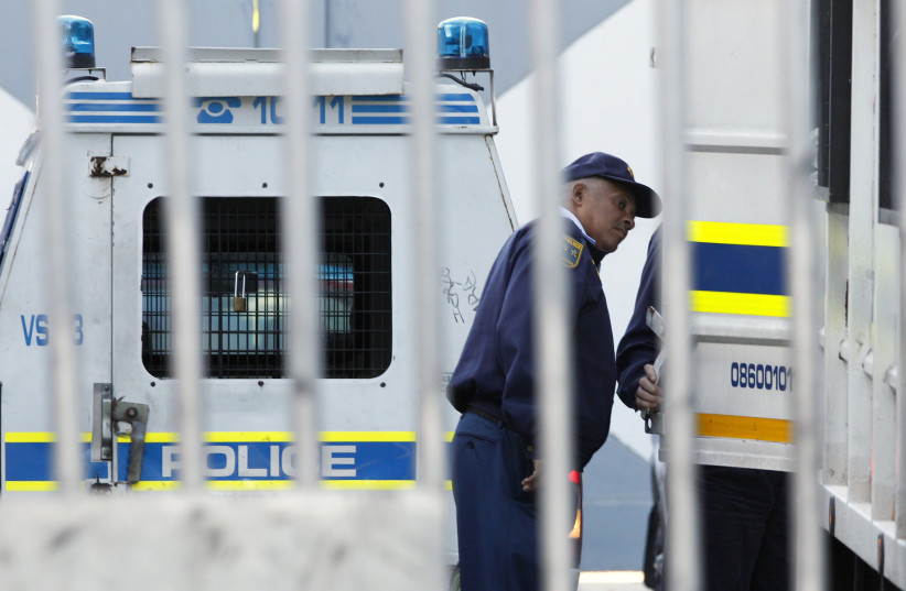 Police outside a Cape Town court (photo credit: REUTERS/MIKE HUTCHINGS)