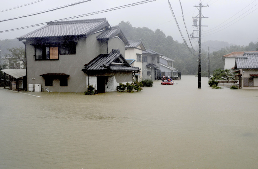 Heavy rains caused by Typhoon Hagibis flood a residential area in Ise, central Japan, in this photo taken by Kyodo October 12, 2019 (photo credit: KYODO/VIA REUTERS)