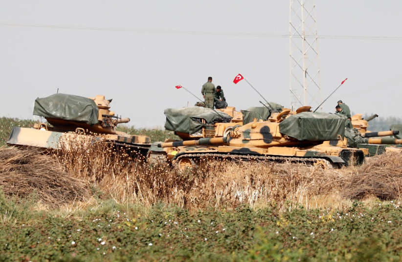 Turkish soldiers stand on top of tanks near the Turkish-Syrian border in Sanliurfa province, Turkey, October 15, 2019. (photo credit: REUTERS/MURAD SEZER)