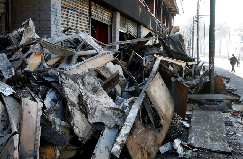 Debris of a burnt and looted supermarket are seen one day after a protest against the government in Valparaiso (photo credit: RODRIGO GARRIDO/REUTERS)