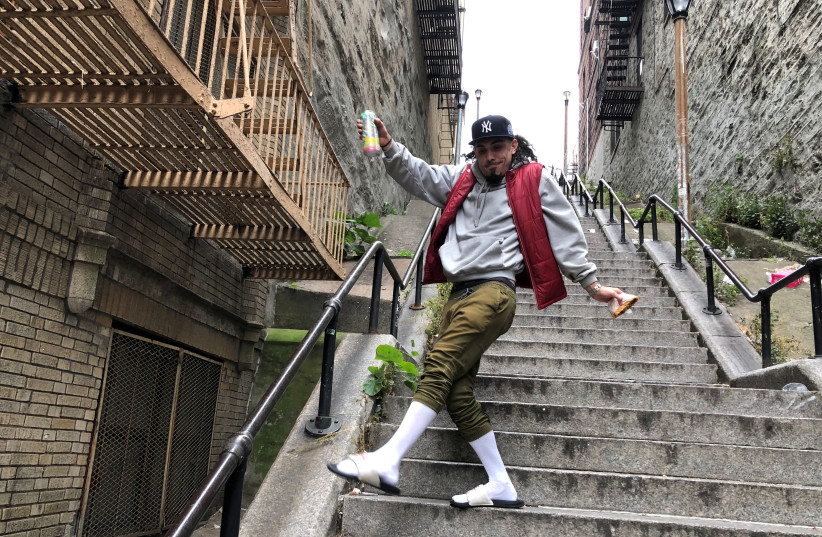 Jay Garcia, a radio host from Queens, dances down the "Joker Steps" in the Bronx borough of New York, U.S., October 16, 2019. Picture taken October 16, 2019 (photo credit: REUTERS/ISABELLA JIBILIAN)