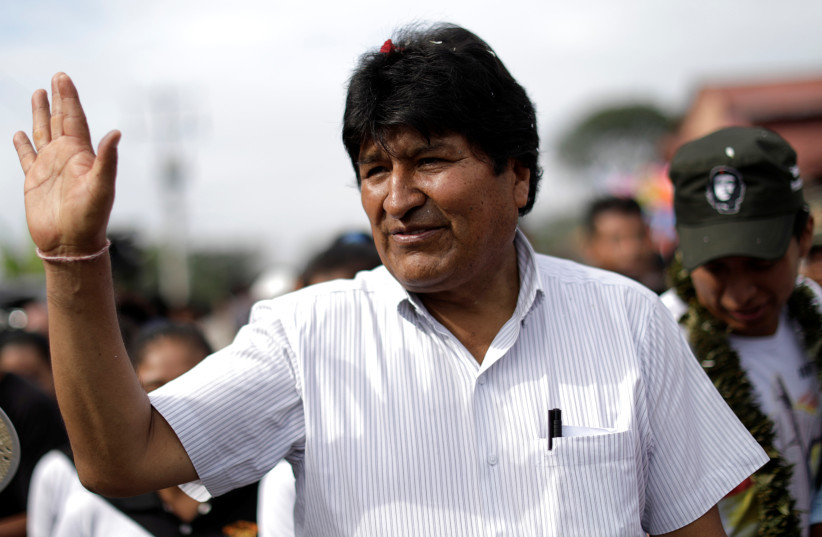 Bolivia's President and candidate Evo Morales of the Movement Toward Socialism (MAS) party waves after voting in the presidential election at a polling station in a school in Villa 14 de Septiembre, in the Chapare region, Bolivia, October 20, 2019 (photo credit: UESLEI MARCELINO/REUTERS)