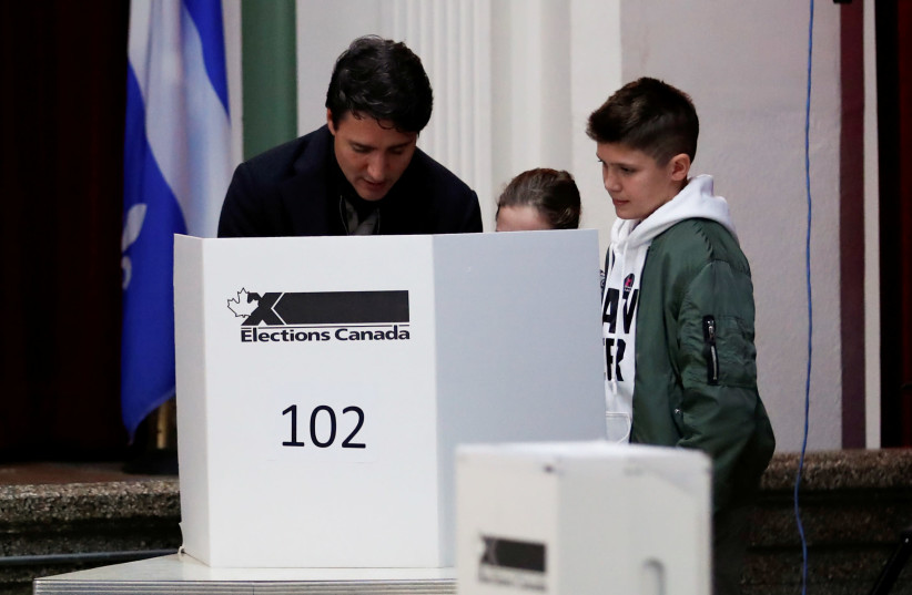 FILE PHOTO: Liberal leader and Canadian Prime Minister Justin Trudeau, accompanied by his son Xavier and his daughter Ella-Grace, votes in the federal election in Montreal, Quebec, Canada October 21, 2019 (photo credit: REUTERS//STEPHANE MAHE/FILE PHOTO)