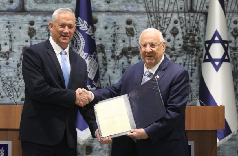 Blue and White leader Benny Gantz (L) receives the mandate to form a government from President Reuven Rivlin, October 23 2019 (photo credit: MARC ISRAEL SELLEM)