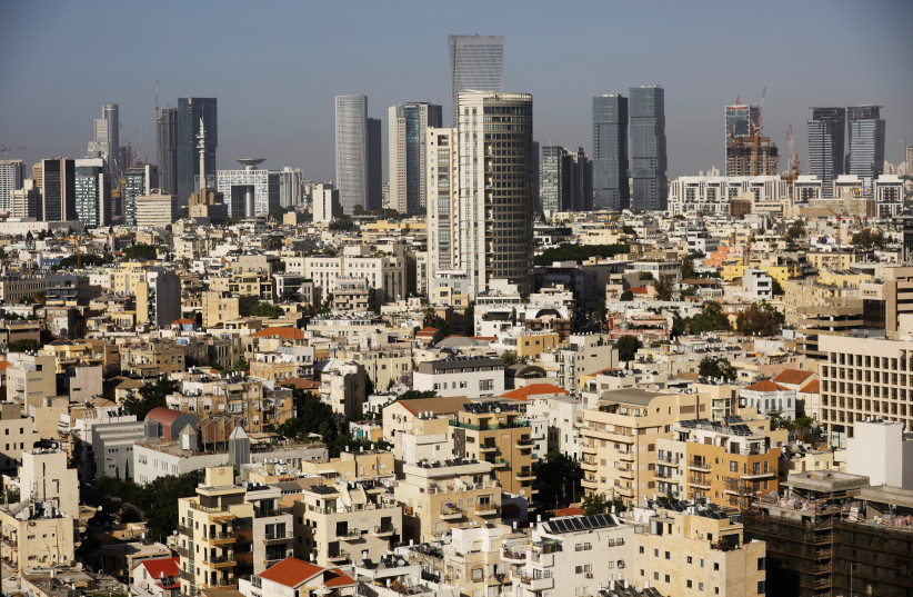 A general view of Tel Aviv's skyline is seen through a hotel window in Tel Aviv, Israel May 15, 2017. Picture taken May 15, 2017 (photo credit: AMIR COHEN/REUTERS)
