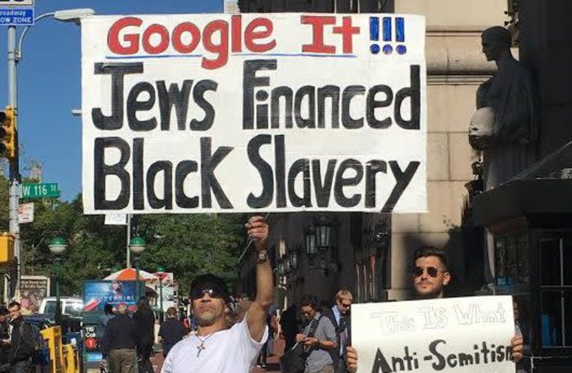 In October 2016, an individual held a sign and walked around the campus gates that said, “Google it!!! Jews financed black slavery.” (photo credit: Courtesy)