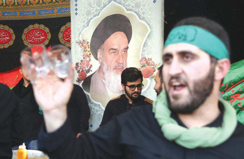 A POSTER OF Iran’s late leader Ayatollah Ruhollah Khomeini is seen while Iranian people commemorate the Shia Muslim holiday Arbaeen in Tehran, last week.  (photo credit: NAZANIN TABATABAEE/WANA VIA REUTERS)