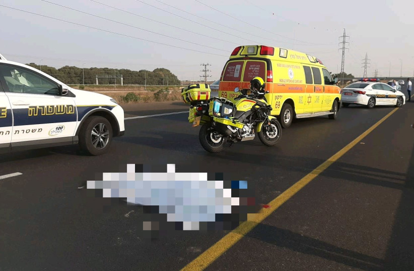 The body of a 24-year-old lying on the road after a possible hit-and-run accident in central Israel (photo credit: MDA)