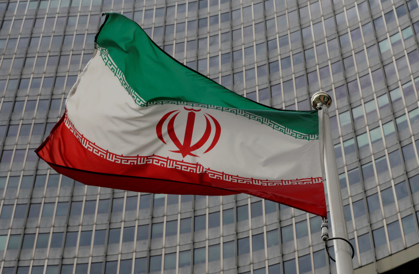 An Iranian flag flutters in front of the International Atomic Energy Agency (IAEA) headquarters in Vienna, Austria September 9, 2019 (photo credit: LEONHARD FOEGER / REUTERS)