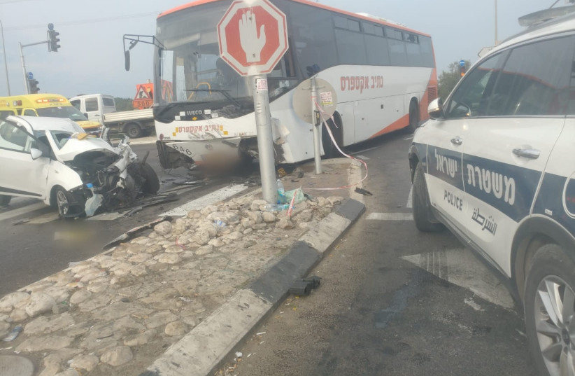 A deadly car crash between a bus and a private car killed one woman. (photo credit: POLICE SPOKESPERSON'S UNIT)