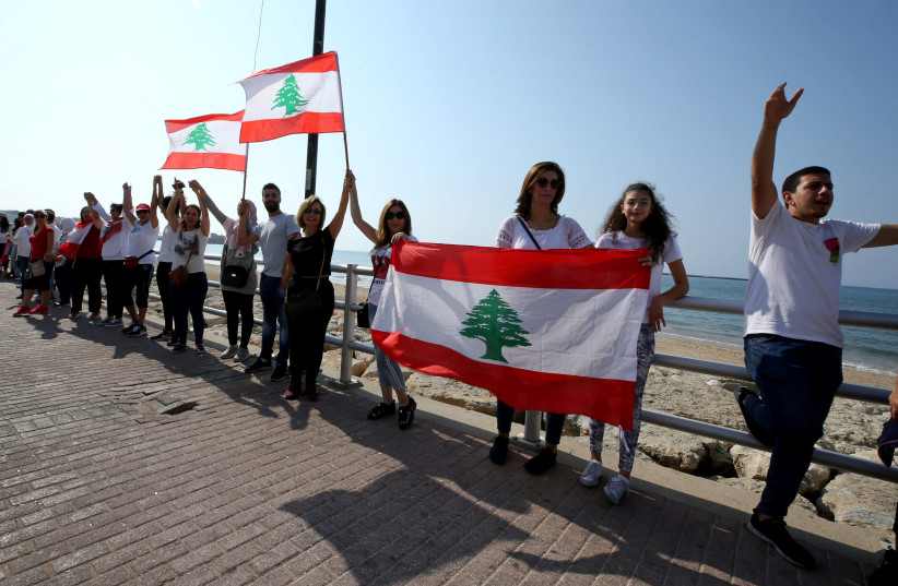 Demonstrators form a human chain during ongoing anti-government protests in Sidon, Lebanon October 27, 2019 (photo credit: REUTERS/ALI HASHISHO)