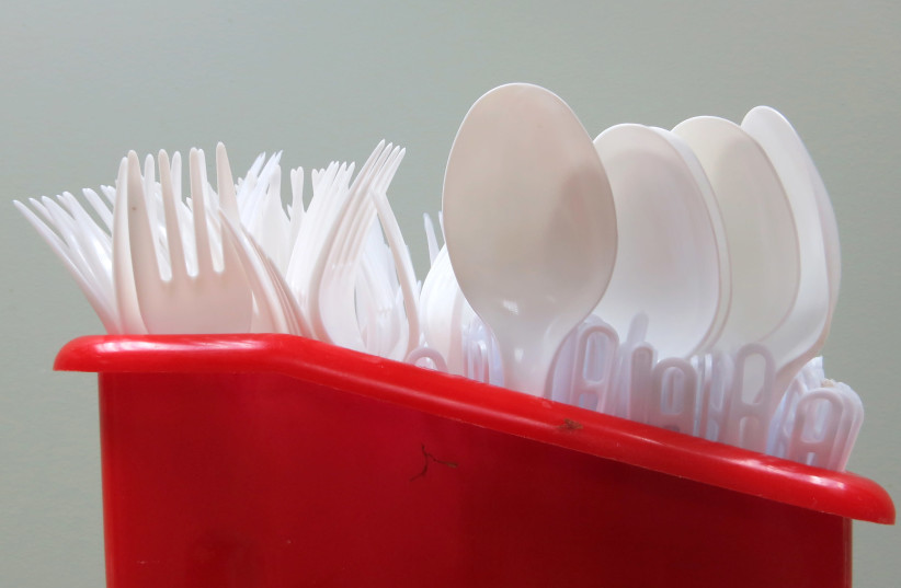 Plastic spoons and forks. (credit: GLEB GARANICH/REUTERS)