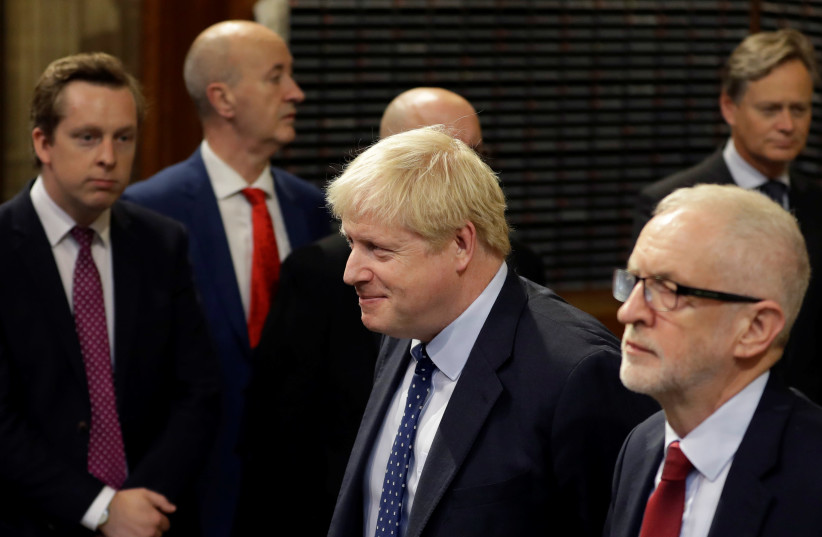 Britain's Prime Minister Boris Johnson and opposition Labour Party Leader Jeremy Corbyn walk through the Commons Members Lobby in Parliament, London, Britain, October 14, 2019 (photo credit: REUTERS/KIRSTY WIGGLESWORTH/POOL)