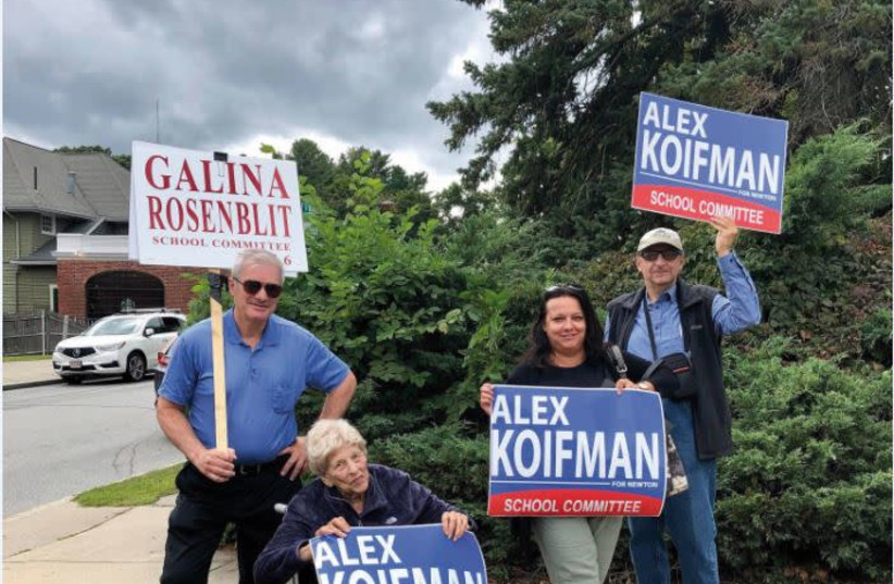 Holding a sign with Koifman's name on (photo credit: Courtesy)