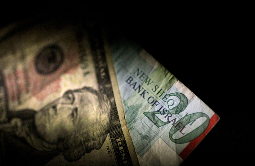 Shekels and dollars (photo credit: THOMAS WHITE / REUTERS)