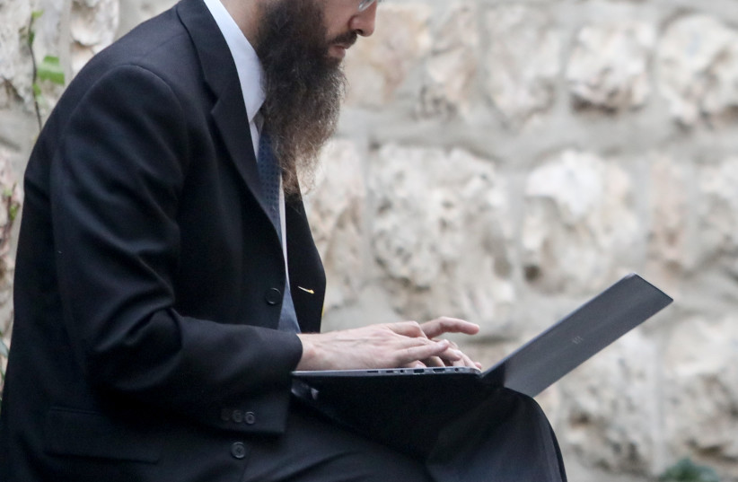 Orthodox Jew and computer Betsalel St in Jerusalem  (photo credit: MARC ISRAEL SELLEM)