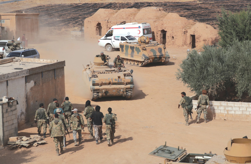 TURKISH-BACKED Jihadists drive a tank near Tel Abyad in Syria. (photo credit: REUTERS)