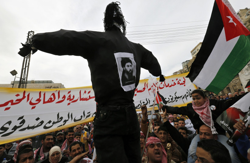 Jordanian protesters carry an effigy of ISIS leader Abu Bakr al-Baghdadi in Amman in February 2015, following the video of the particularly gruesome killing of pilot Muath al-Kaseasbeh. (credit: MUHAMMAD HAMED/REUTERS)
