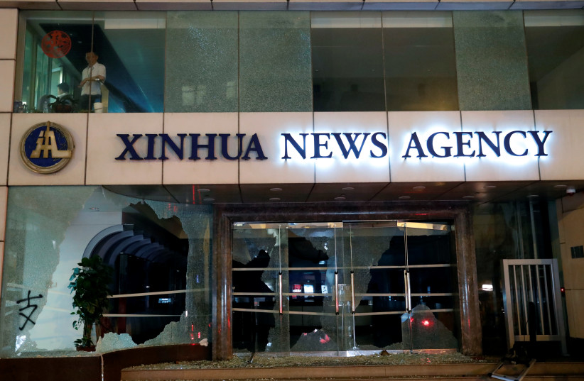 Damaged entrance of China's official Xinhua news agency is seen during anti-government protest in Hong Kong, China November 2, 2019 (photo credit: TYRONE SIU/ REUTERS)