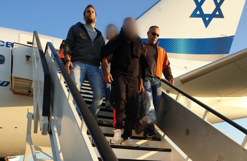 58-year-old Israeli suspect extradited from Thailand, to be questioned for involvement in assault of multiple minors (photo credit: ISRAEL POLICE)
