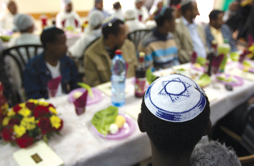 New olim from Ethiopia attend a dinner in Israel.   (photo credit: REUTERS)