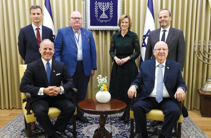 COMBATANTS AGAINST antisemitism. Seated, left to right: Elan Carr, Reuven Rivlin. Standing: Frederic Potier, Lord Eric Pickles, Katharina von Schnurbein and Dr. Felix Klein (photo credit: Mark Neiman/GPO)