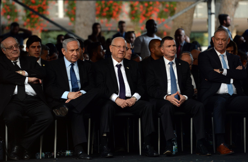 Prime Minister Benjamin Netanyahu sits alongside President Revuen Rivlin at the Israeli government's memorial for Yitzhak Rabin, November 10, 2019 (photo credit: HAIM ZACH/GPO)