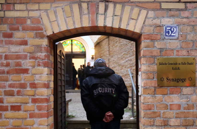 A security officer walks at the synagogue in Halle, Germany October 11, 2019, after two people were killed in a shooting (photo credit: REUTERS/HANNIBAL HANSCHKE)