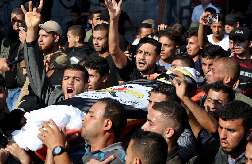 Mourners carry the body of Palestinian Islamic Jihad field commander Baha Abu Al-Atta during his funeral in Gaza City November 12, 2019 (photo credit: REUTERS)