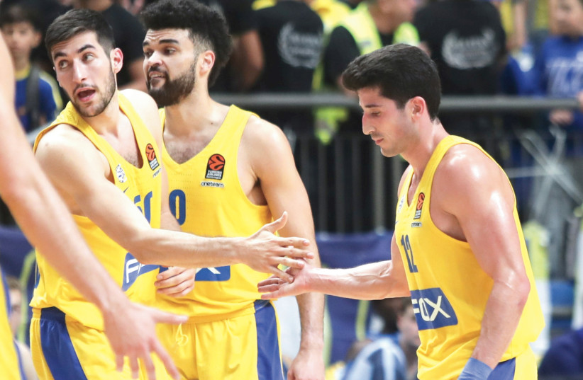 MACCABI TEL AVIV players celebrate after defeating host Hapoel Eilat 97-76 in State Cup round-of-16 action. (photo credit: DANNY MARON)