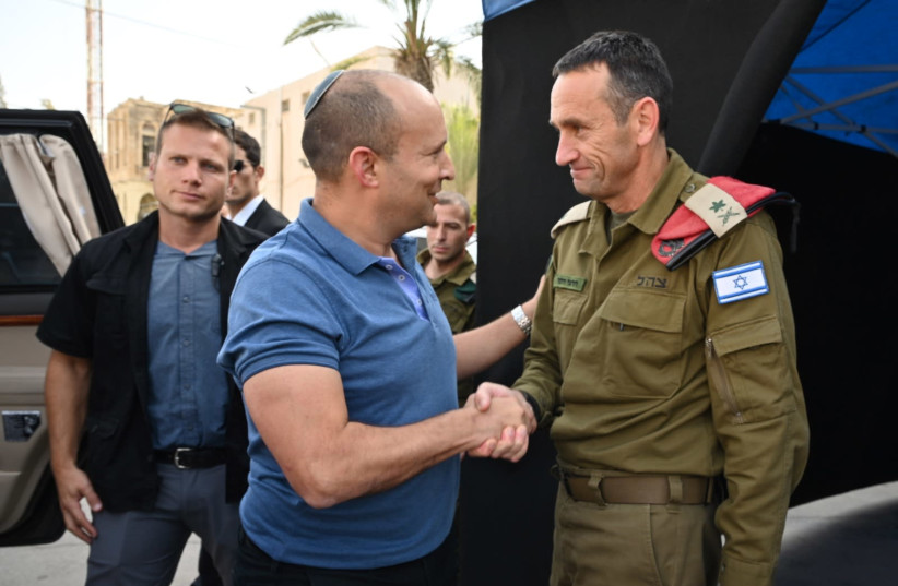 Defense Minister Naftali Bennett [L] shaking hands with IDF Major General Herzi Halevi [R]    (photo credit: ARIEL HERMONI/DEFENSE MINISTRY)